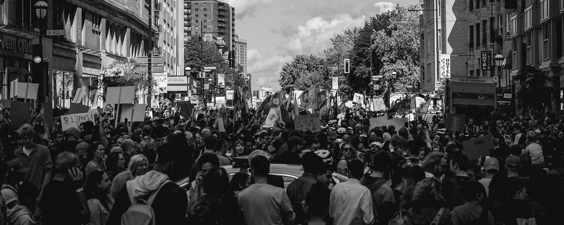 A large of protesters march down the street