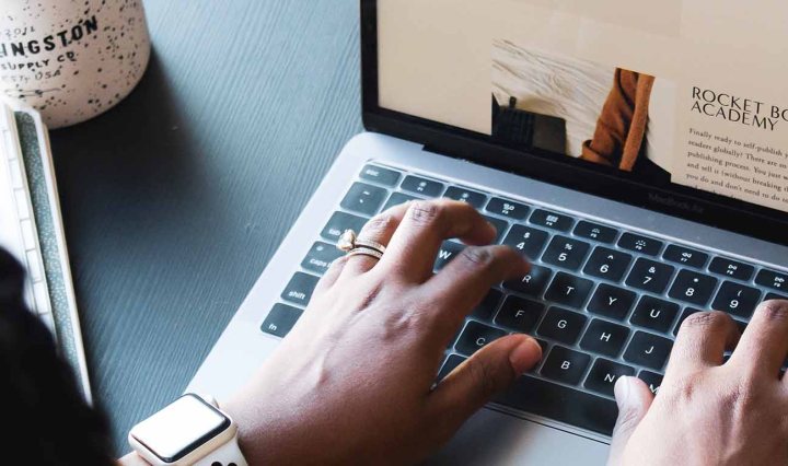 A person types on a laptop