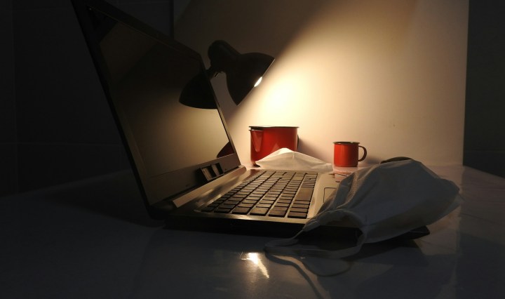 A laptop by lamp light