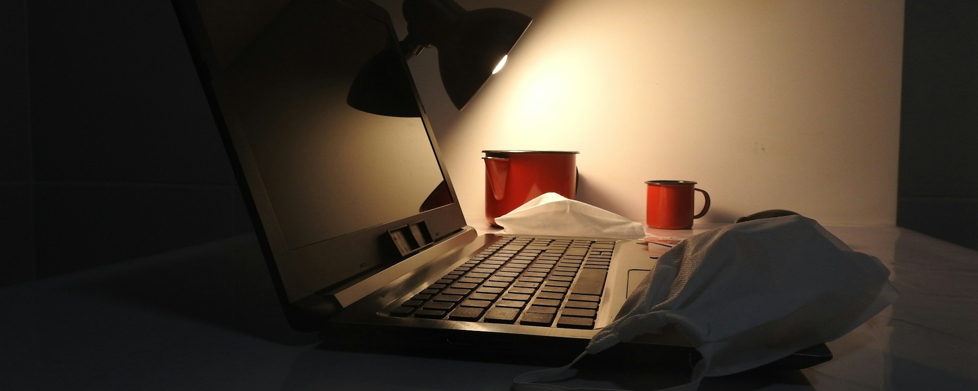 A laptop by lamp light