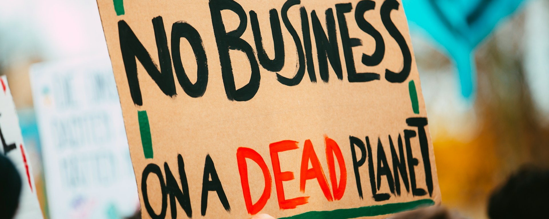Protesters hold a sign that reads: no business on a dead planet