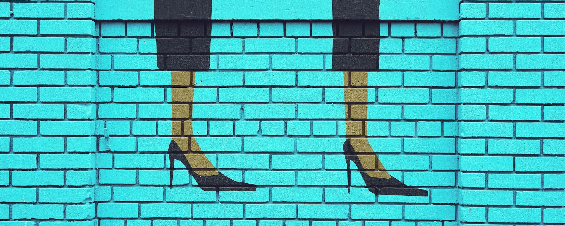Street art on a wall showing high heels