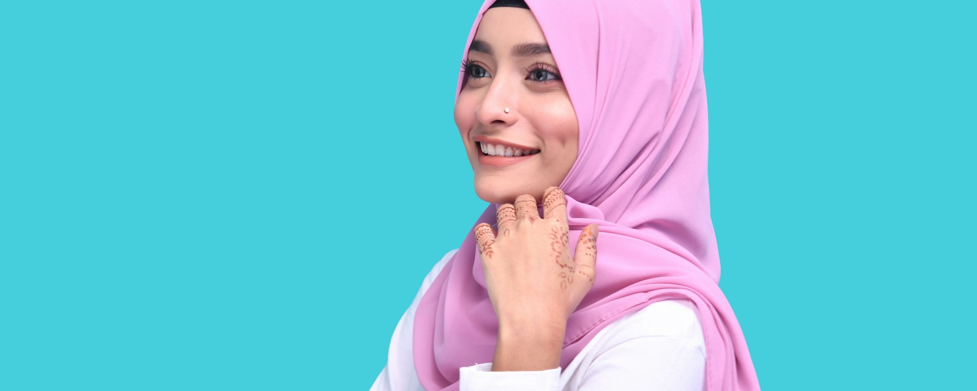 Woman wearing a pink hijab smiles