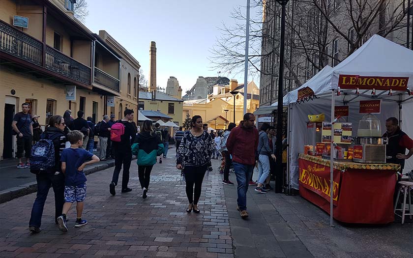 People walk through a market in Sydney