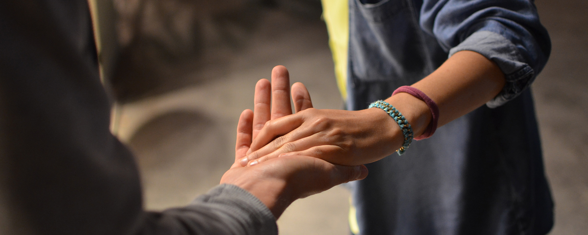 Close up of two people with outstretched hands touching