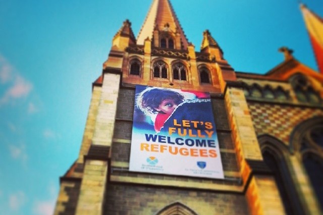 Sign above St Paul's Cathedral, Melbourne, says: Let's fully welcome refugees