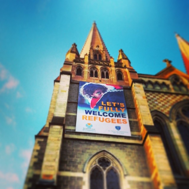 Sign above St Paul's Cathedral, Melbourne, says: Let's fully welcome refugees