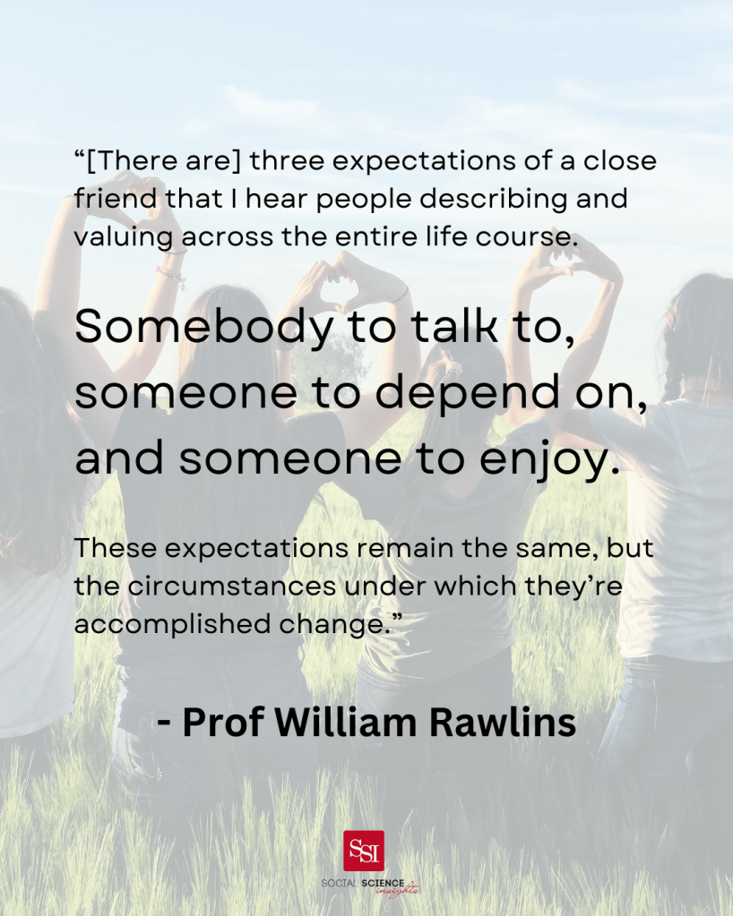 Girls sit with their back to the camea, interlocking their hands to make love hearts