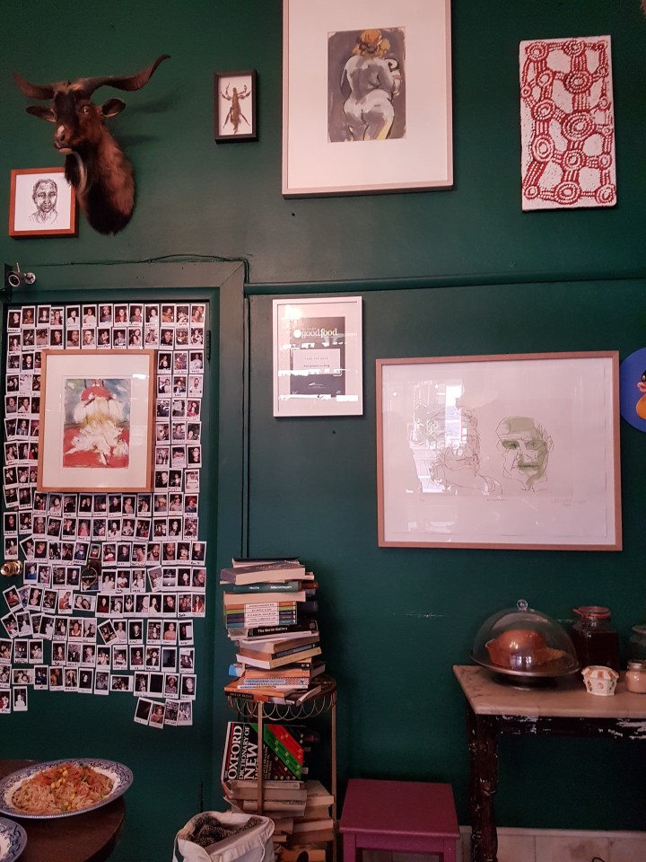 A wall of polaroids and framed pictures