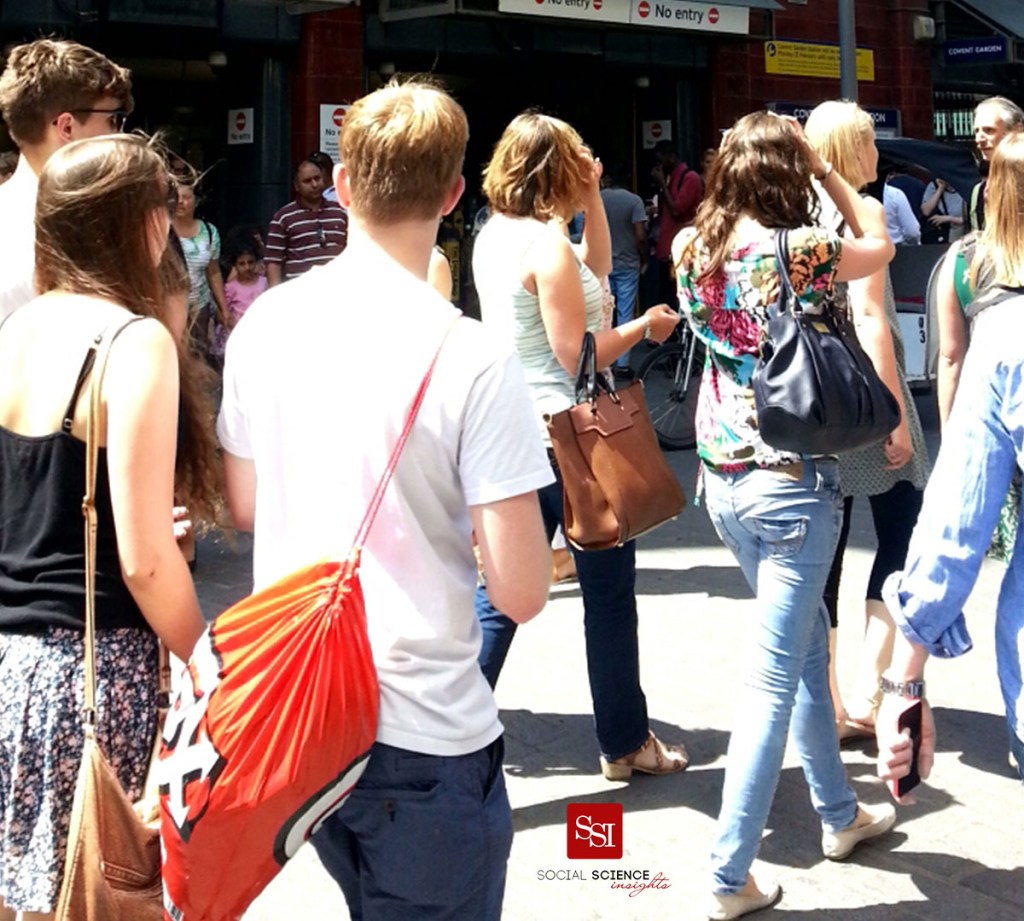 People walk down a street on a sunny day