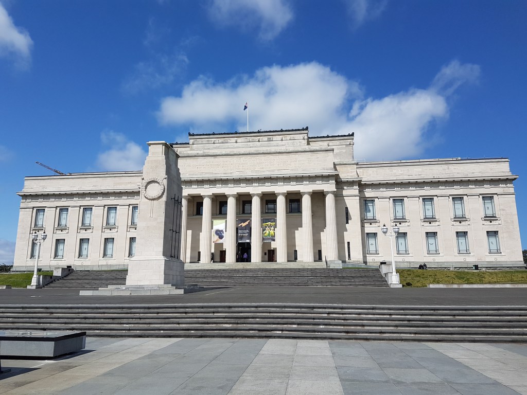 Entrance to the Auckland Museum is a gigantic white building with tall columns