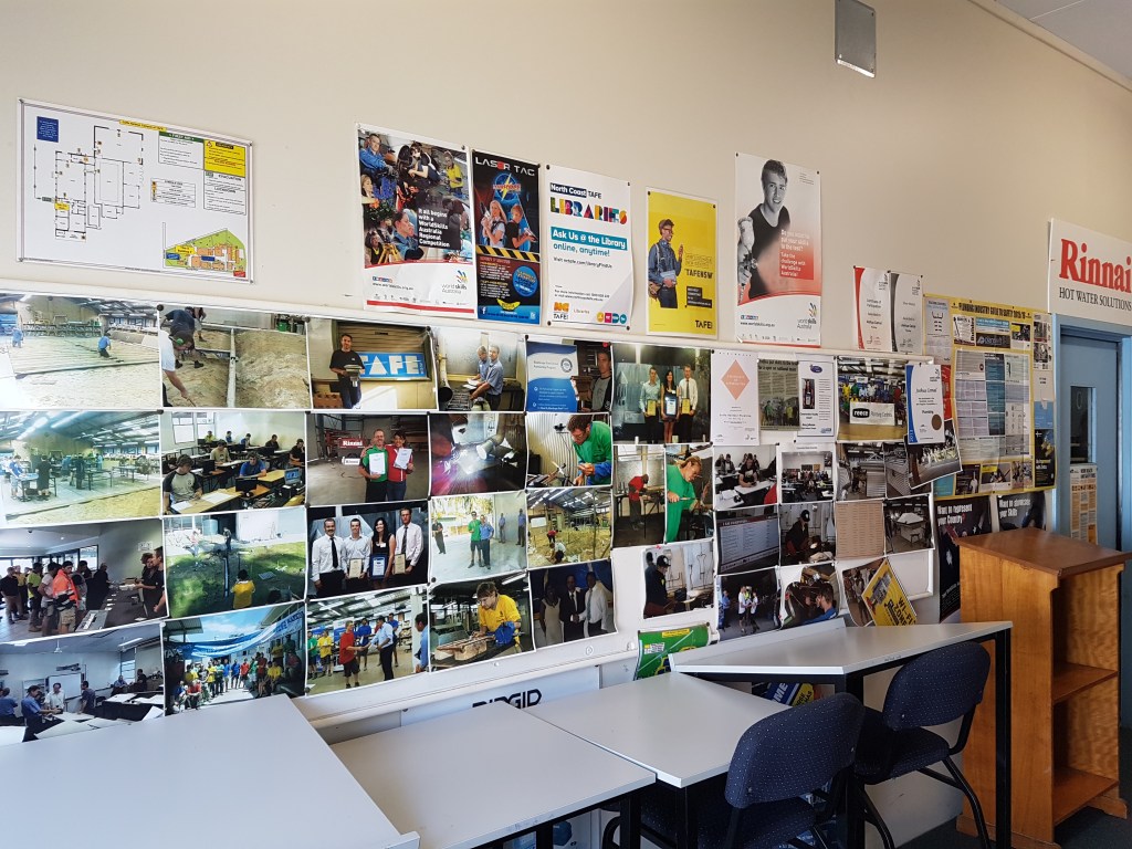 Inside of a workshop, with a large photo board