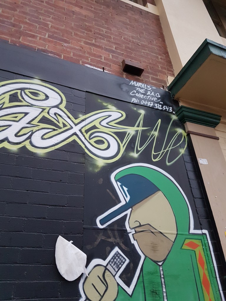 Street art of a man wearing a hoodie