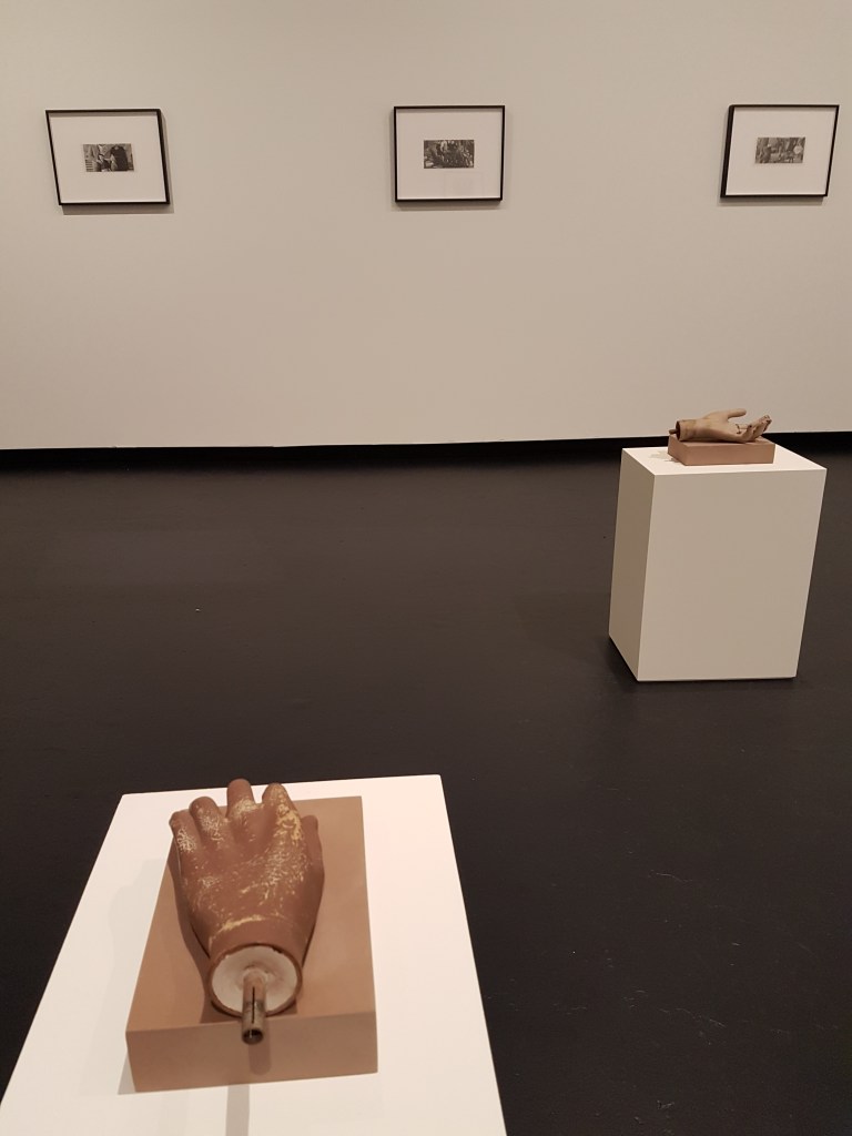 Sculptures of hands in a large gallery space
