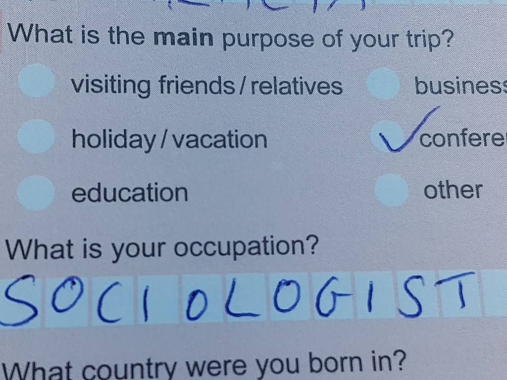 Part of my immigration card. Under the question 'what is the main purpose of your trip, I ticked 'conference.' Under 'What is your occupation,' I wrote, 'Sociologist'