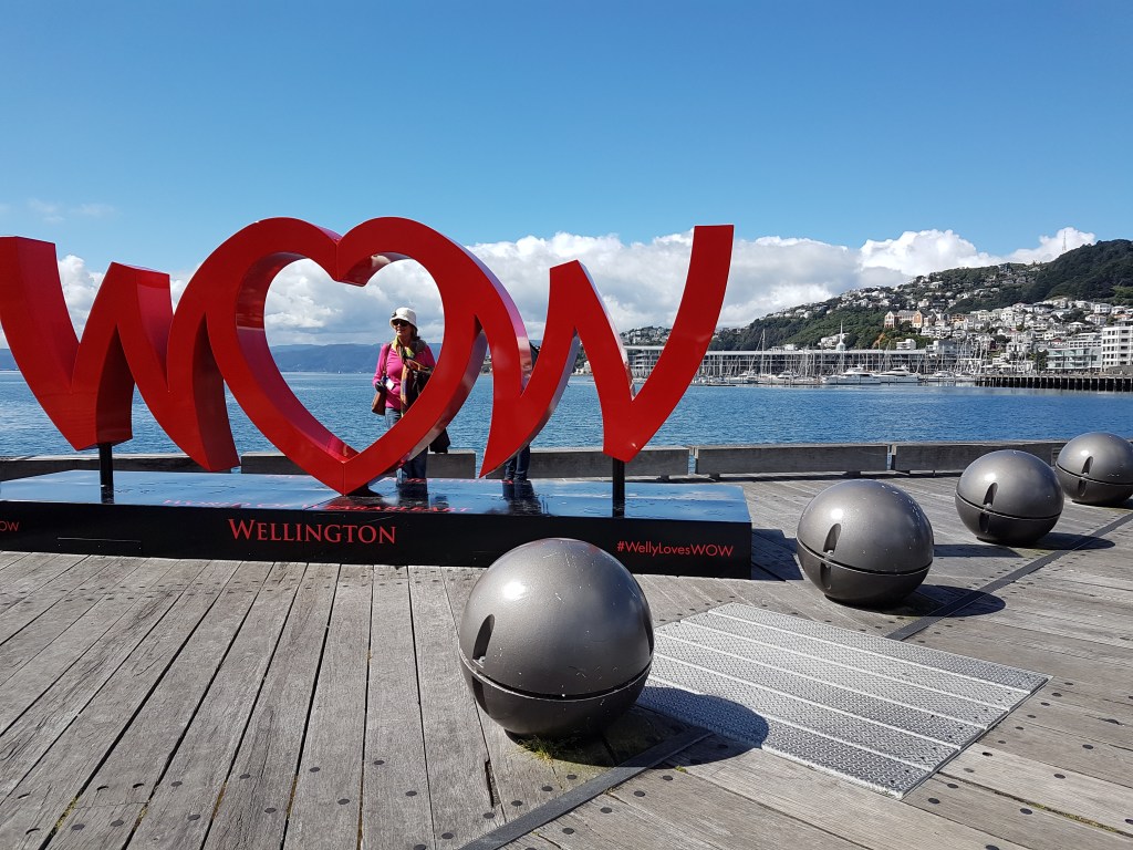 A huge red sign that says WOW, and an outdoor installation of four large silver sphered scultures