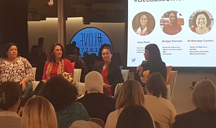 Aboriginal women speakers sit up front of an audience at Twitter Australia headquarters