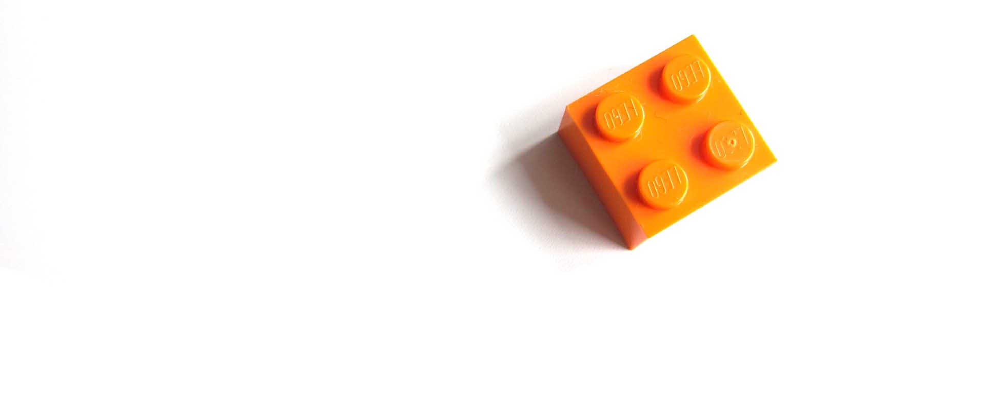 Orange lego block against a white background