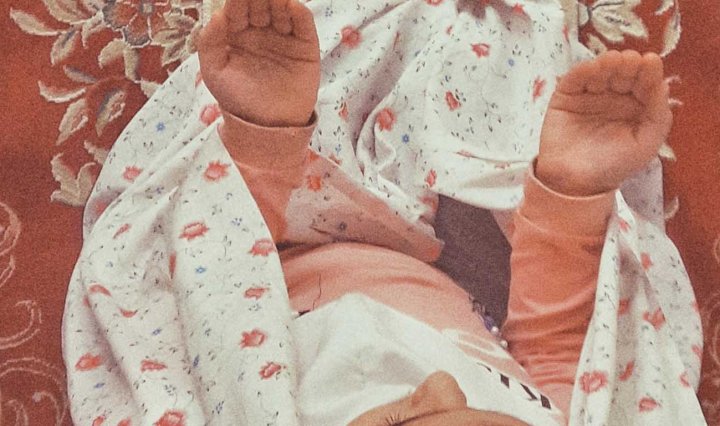 Aerial image of a young Muslim girl praying