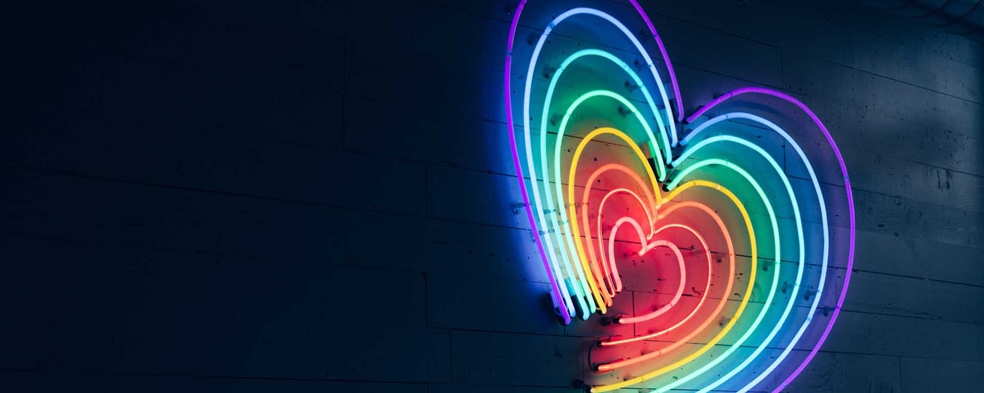 A neon sign in the colours of the Pride Flag