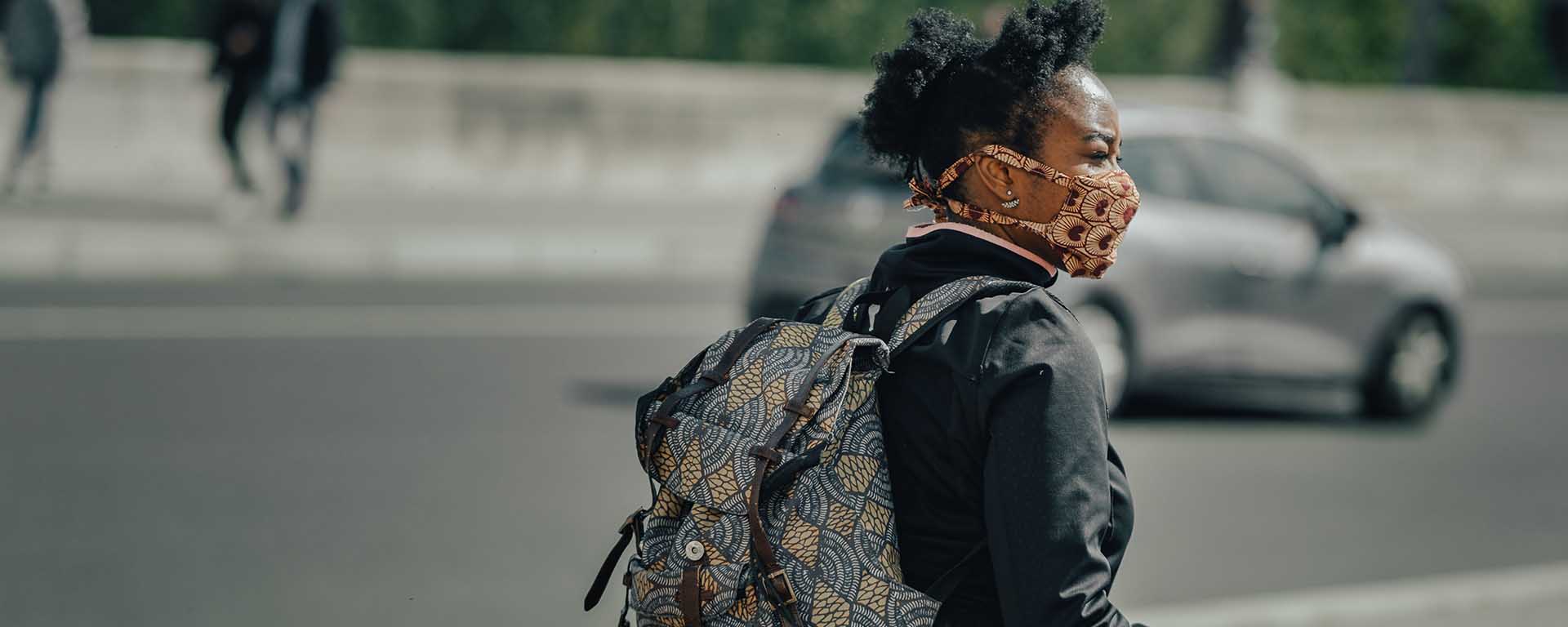 A young Black woman wears a COVID-19 face mask
