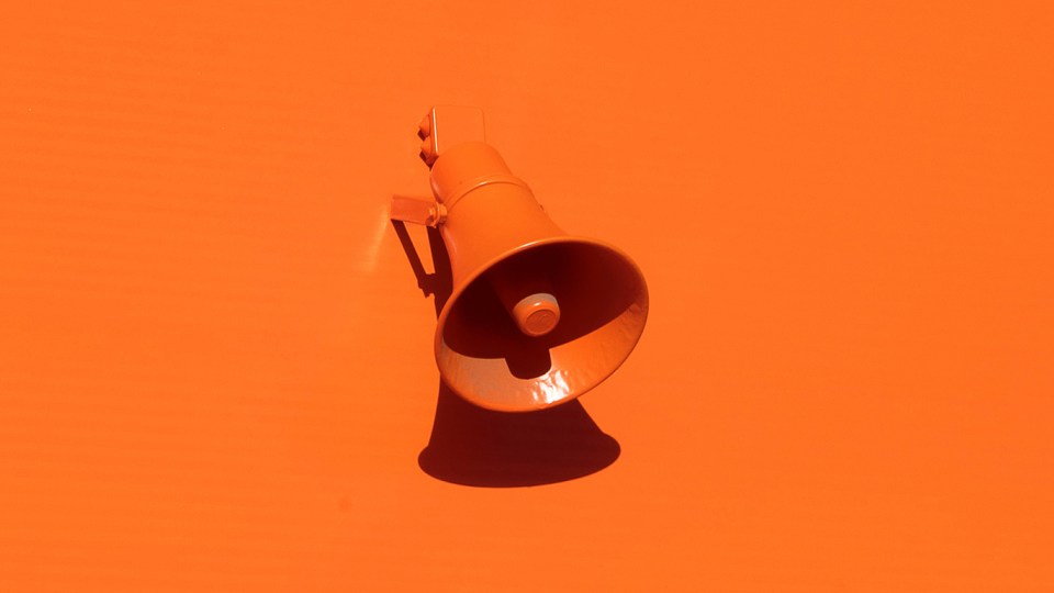 Orange wall with orange megaphone