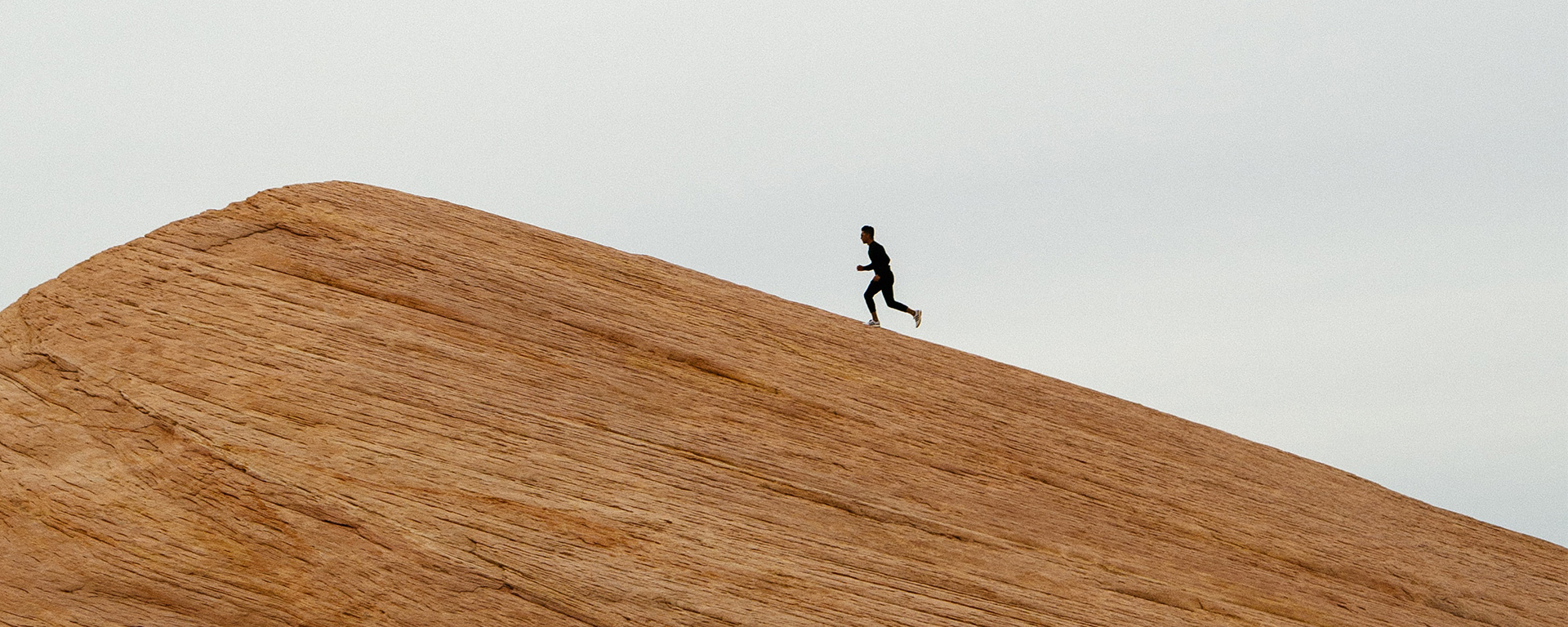 A person runs up a steep mountain