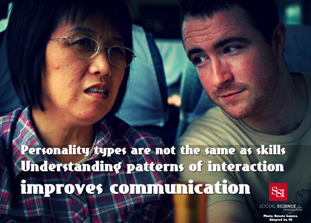 An Asian woman is mid-sentence, while a White man is leaning in and listening intently