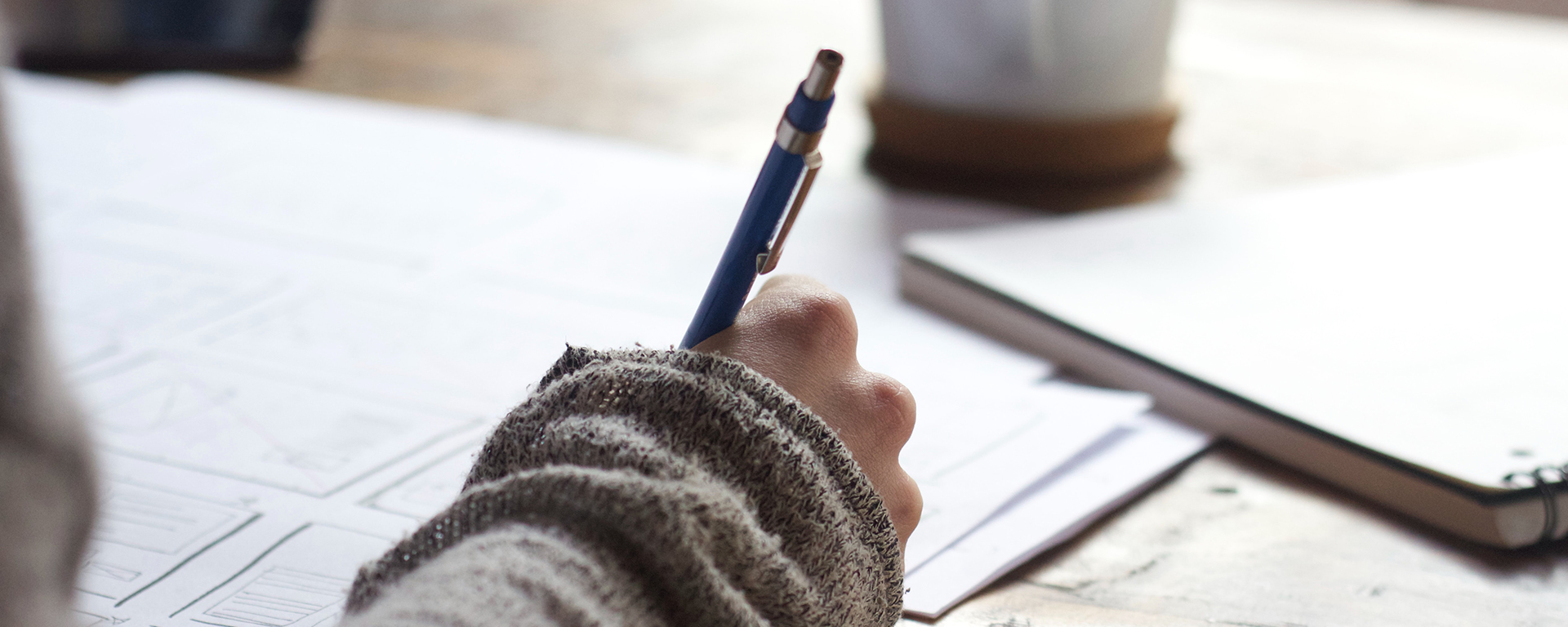 Close up of a woman's hand, writing with a pen