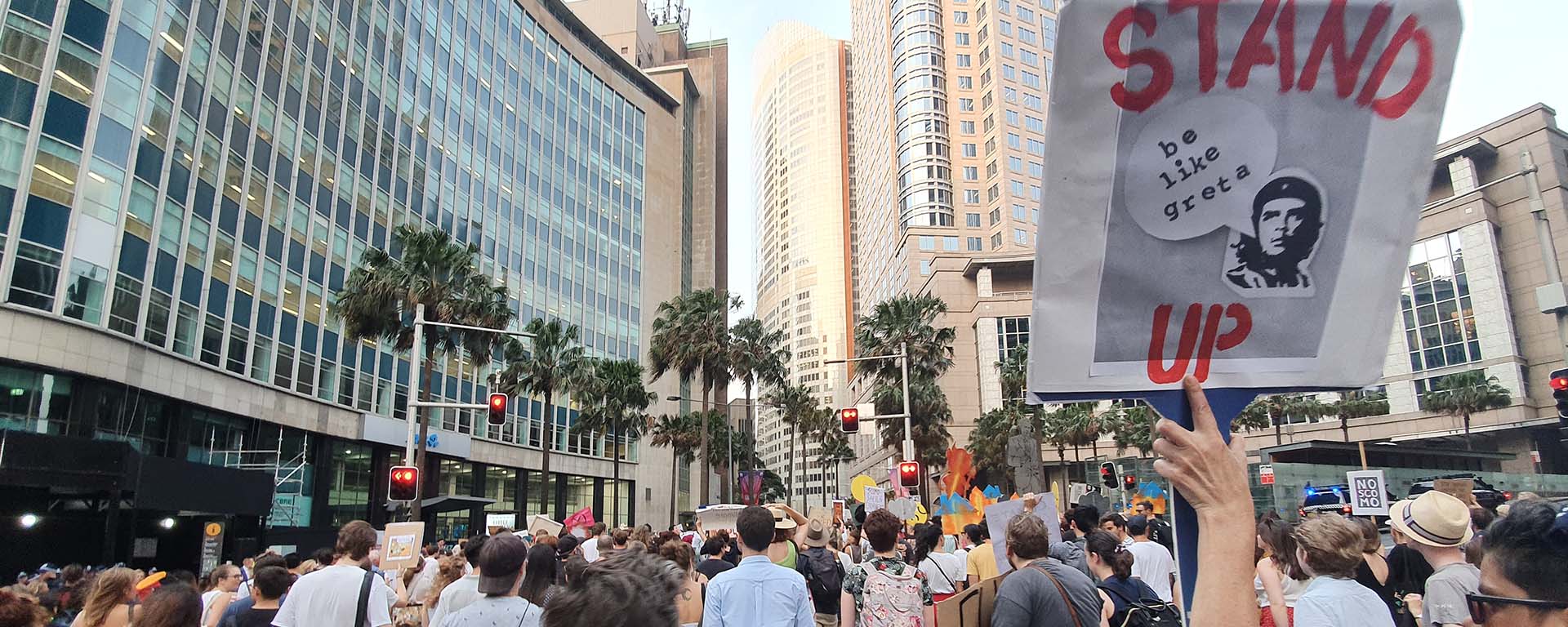 Crowd of protesters in Sydney. Sign with Che Guevara reads: Stand up. Be like Greta