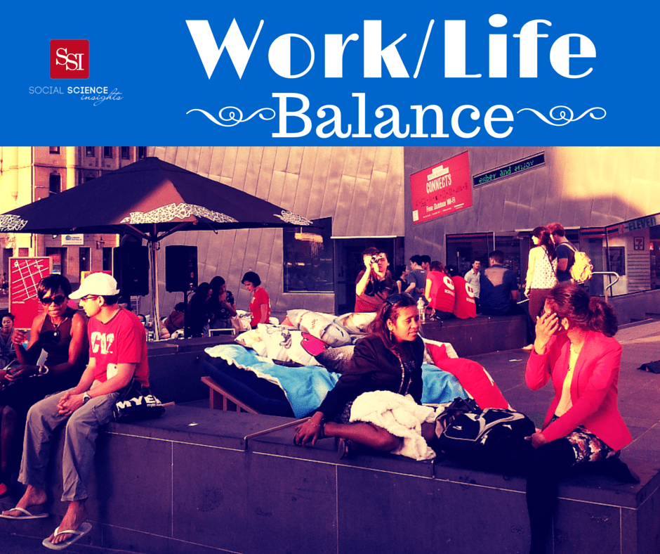 People sit and talk outdoors in Federation Square, Melbourne