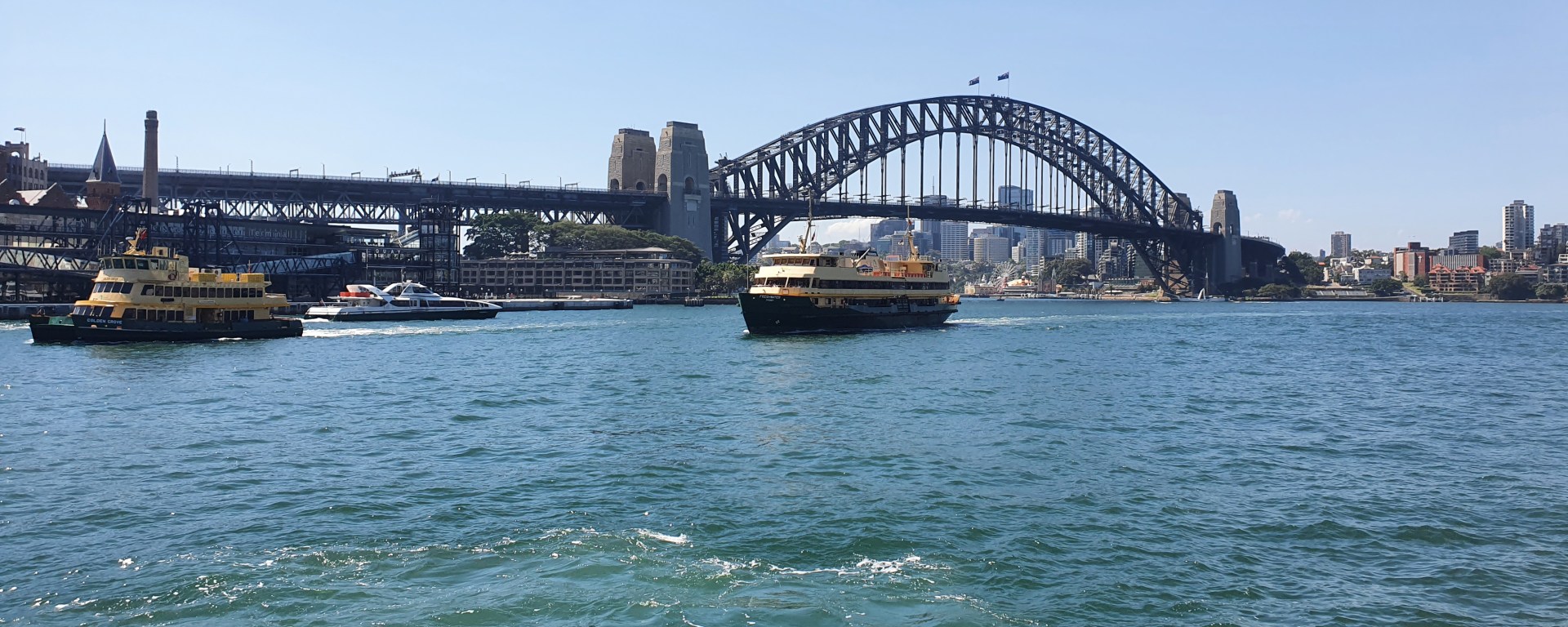 The ferry sails by the Sydney Harbour Bridge