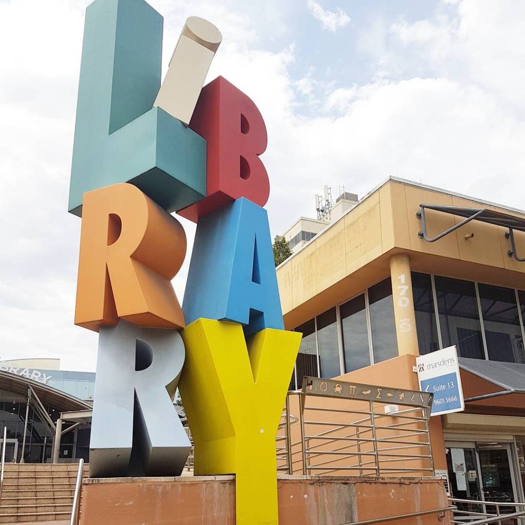 A colourful sculpture that says Library