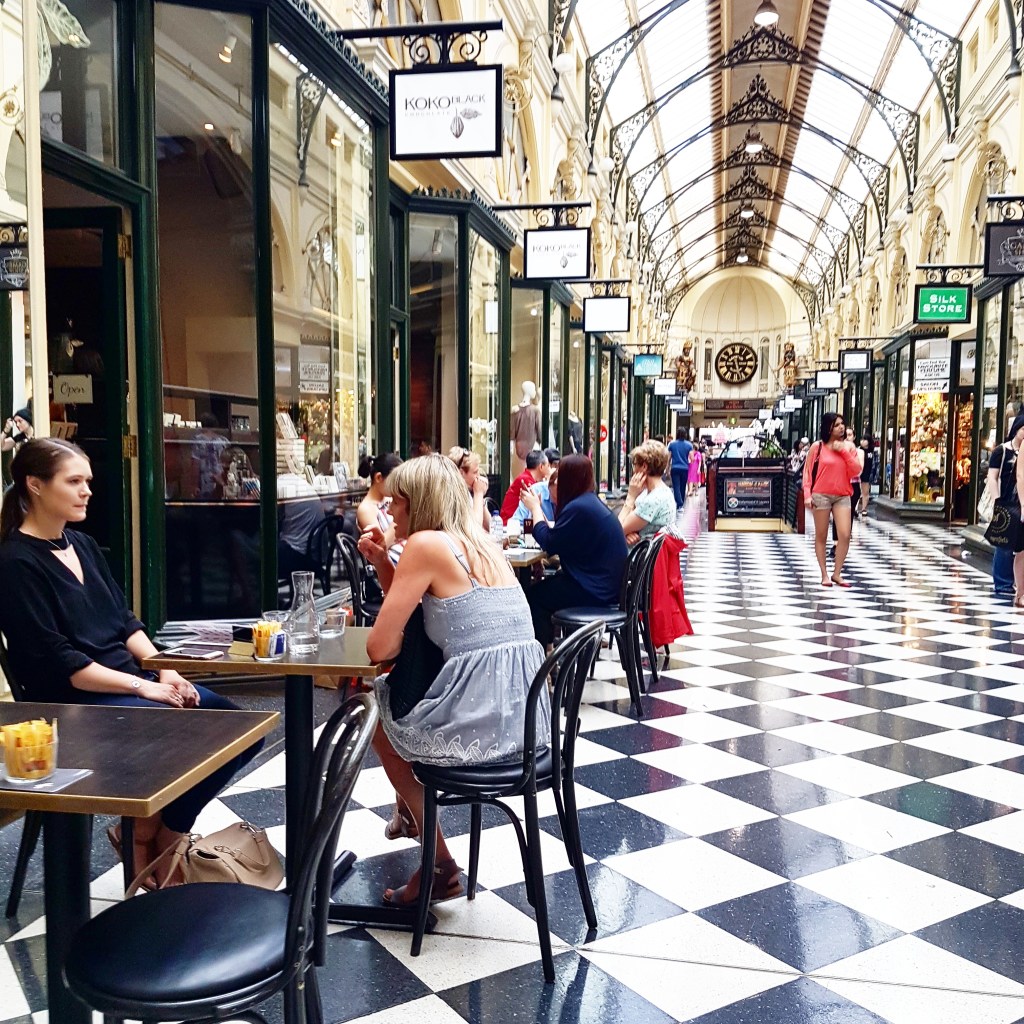 People sit at an outdoors cafe in Melbourne