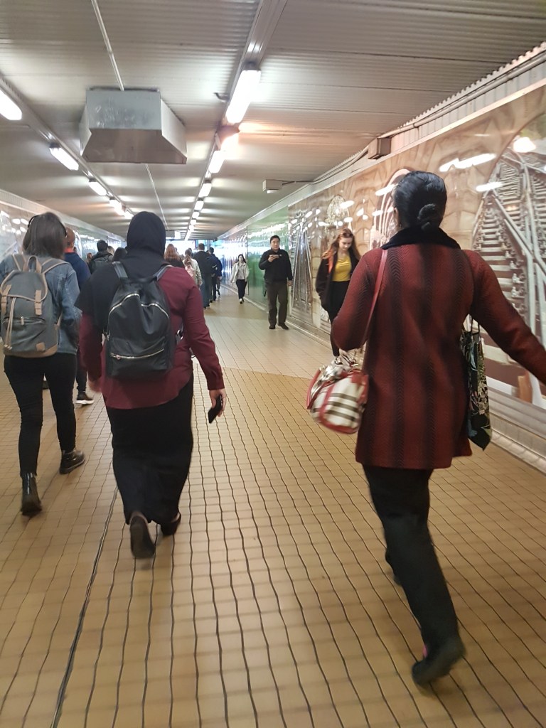 Commuters walk underground Central Station