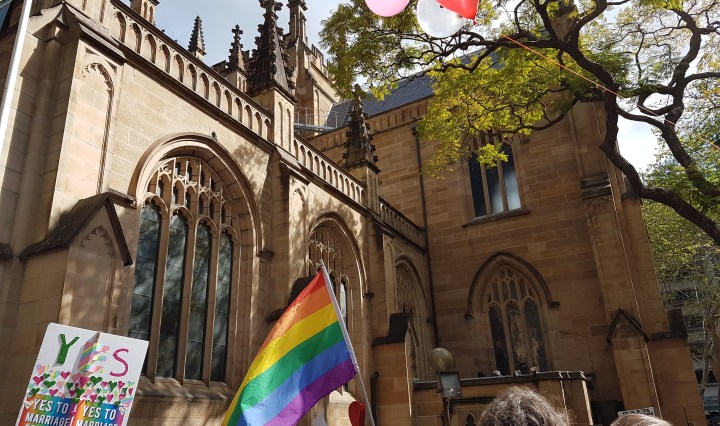 The Pride Flag and a sign saying "YES" at the Marriage Equality march in Sydney