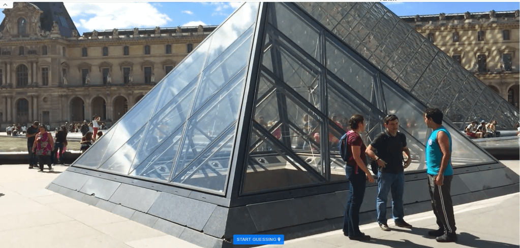 Three people stand outside the Louvre Museum in Paris, France