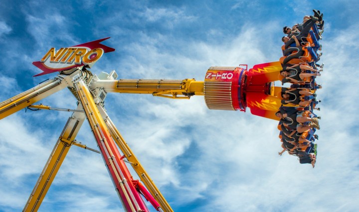 People swinging mid-air in the 'Nitro,' a carnival ride at the Perth Royal Show