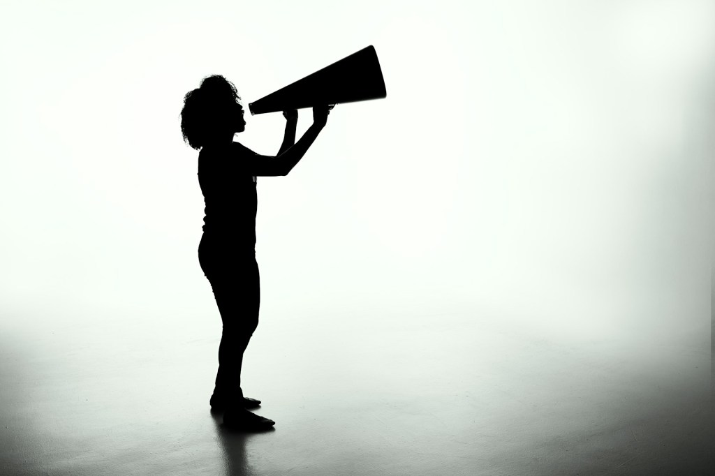 Silhouette of a woman holding a megaphone