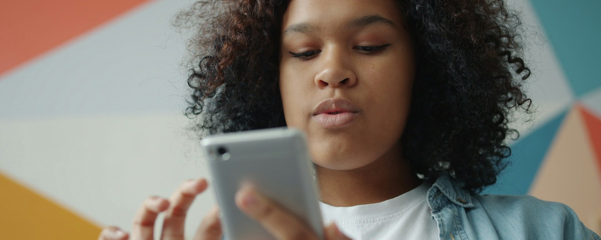 Young Black woman scrolling on her phone