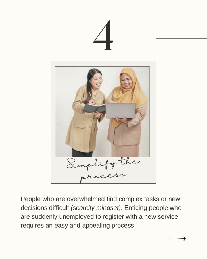 Two Filipina women smile while holding a book and laptop