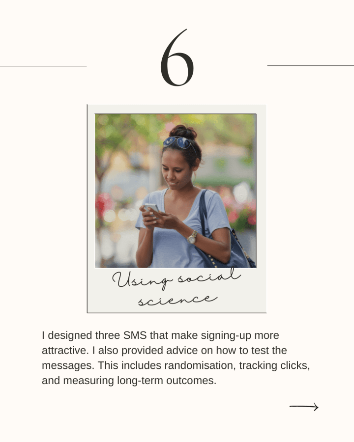 An Aboriginal woman smiles while writing on her phone outdoors