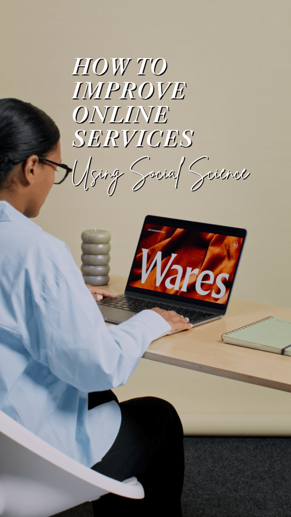 A Black woman is seen from the side typing on a laptop