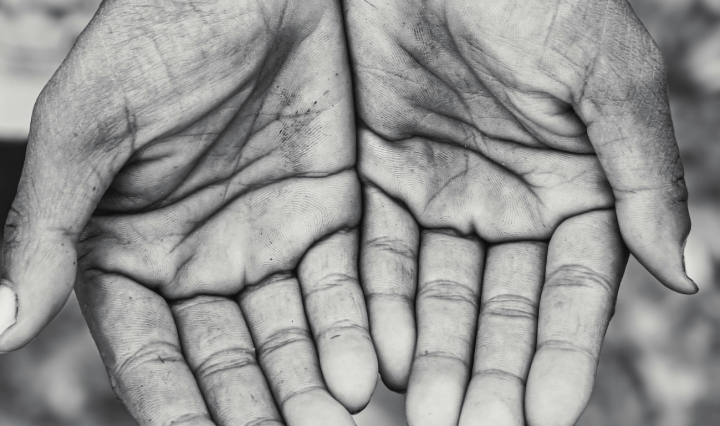 Black and white photo of hands held out, palms up