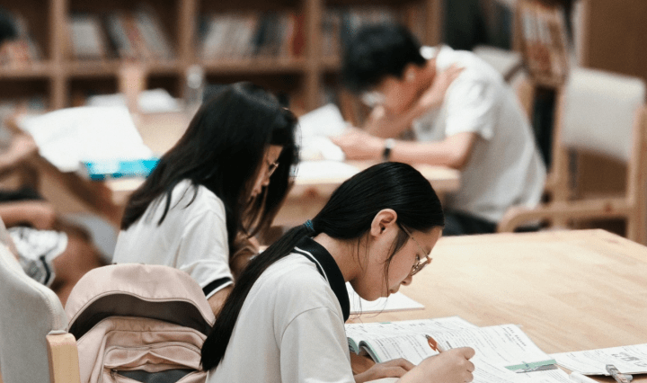 Asian students study in a library