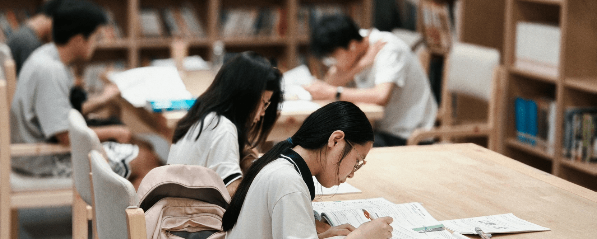 Asian students study in a library
