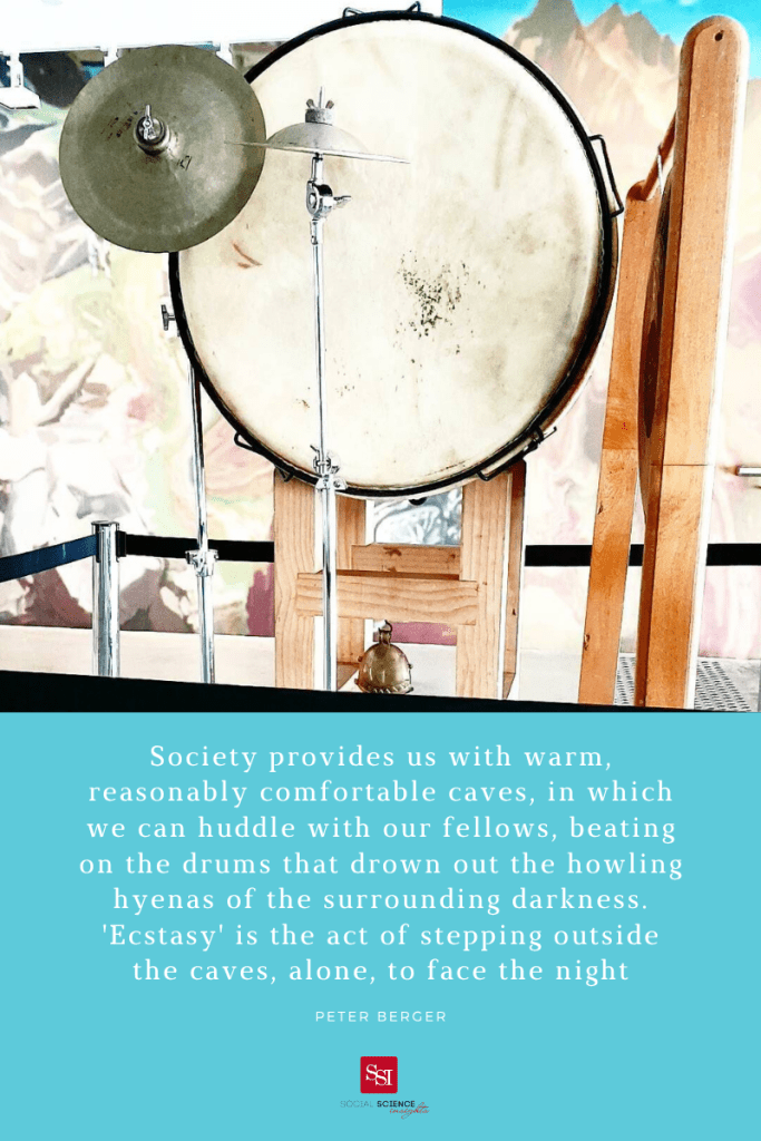 A beautiful white drum suspended. Quote: Society provides us with warm, reasonably comfortable caves, in which we can huddle with our fellows, beating on the drums that drown out the howling hyenas of the surrounding darkness. “ecstasy” is the actor stepping outside the caves alone, to face the night.
